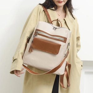 Fashionable large capacity PU leather backpack for women with brown trim and tassel detail