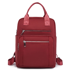 Large dark red quilted nylon backpack with multiple zipper pockets and dual handles