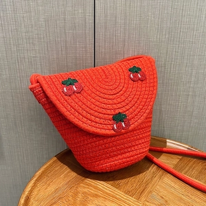 Orange woven cotton rope crossbody bag with cherry embroidery and matching shoulder strap