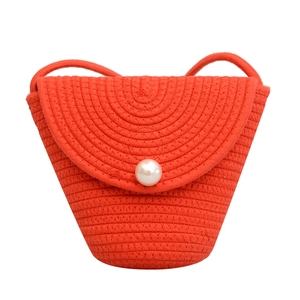 Orange woven cotton rope mini crossbody bag with pearl button closure and spiral pattern