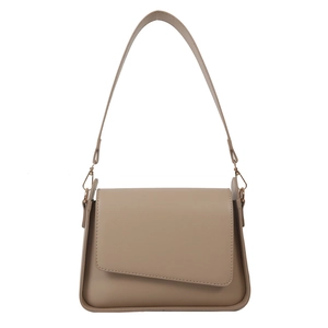 Minimalist beige shoulder bag with asymmetrical flap and sleek matte finish on white background