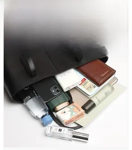 Detailed view of spacious black tote bag interior with multiple compartments and pockets