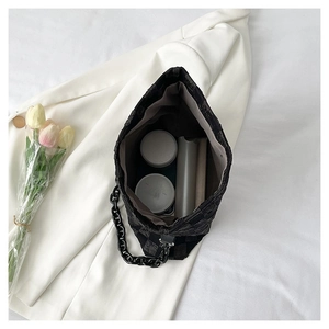 Top view of large black quilted tote bag with chain handle showing spacious interior