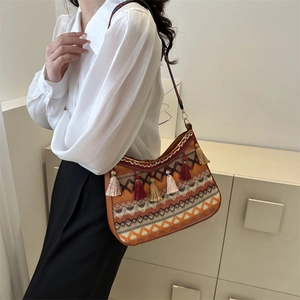 Bohemian woven shoulder bag with colorful tassels and geometric ethnic patterns