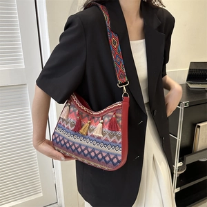 Bohemian geometric woven crossbody bag with colorful tassels and wide shoulder strap