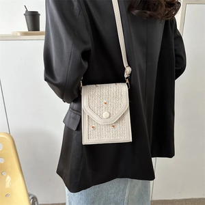 Straw woven crossbody phone bag with daisy embroidery and adjustable strap