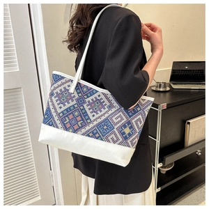 Detailed view of large tote bag featuring colorful geometric woven patterns for daily commute