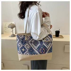 Lifestyle shot of large woven tote bag with blue and pink geometric ethnic patterns