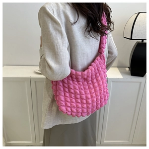 Detailed back view of pink bubble texture hobo bag worn by model in minimalist setting