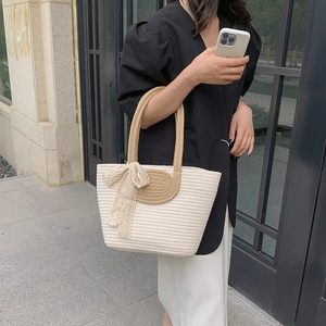 Minimalist white woven tote bag with khaki handles and delicate lace bow detail