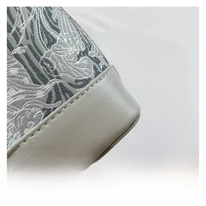 Close-up of vintage print pattern and gray leather stitching with high-quality seam details