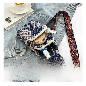 Internal storage detail of ethnic woven chest bag showing phone and cosmetics