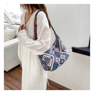Détail du sac bandoulière bohème tissé avec motifs géométriques et sangle brodée colorée