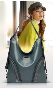 Detail view of the soft PU leather texture and rivet embellishments on a large backpack