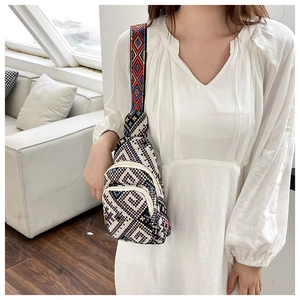 Close-up of ethnic woven chest bag featuring geometric patterns and embroidered wide strap