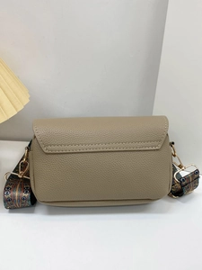 Detail of khaki pebbled leather crossbody bag with ethnic patterned wide strap