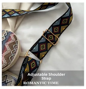 Detail of adjustable geometric patterned strap with gold metal buckle on a woven tote bag