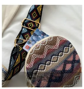 Close-up of ethnic style woven bag showing card slot capacity and metal buckle