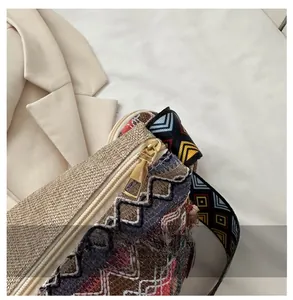 Detail of bohemian ethnic embroidered tote bag with geometric strap and gold zipper
