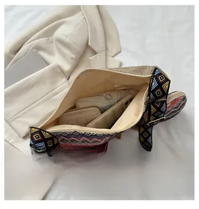Detail view of the spacious interior of the woven beige tote bag holding daily items