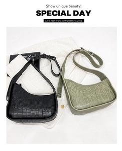 Flat lay of vintage crocodile pattern shoulder bags in black and olive green colors