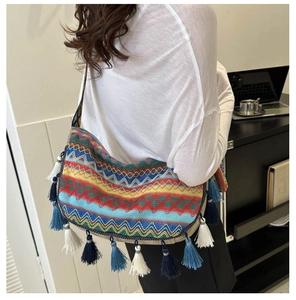 Close-up of a bohemian woven tote bag with colorful geometric patterns and long tassels