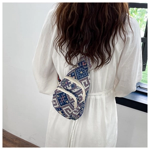 Detailed view of bohemian geometric patterned chest bag with woven jacquard texture