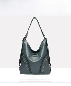 Front view of a blue retro hobo bag with V-shaped zippers and metallic stud details