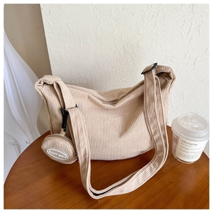 Detail of corduroy crossbody bag texture with matching mini round coin purse attachment