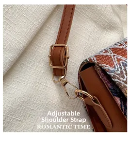Detail of adjustable strap with gold hardware on retro ethnic style shoulder bag