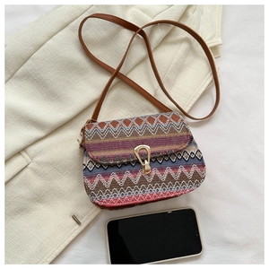 Detail of ethnic geometric woven crossbody bag with metal buckle and leather strap