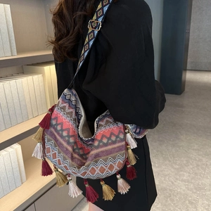 Ethnic bohemian tote bag with colorful geometric patterns and decorative tassels