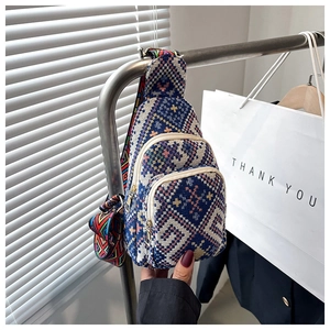 Bohemian style crossbody chest bag with colorful geometric patterns and wide shoulder strap