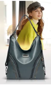 Dark teal faux leather hobo bag with stud detailing and decorative front zippers