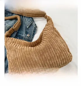 Detail view showing brown corduroy fabric texture on a large capacity tote bag