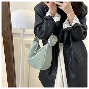 Detail of mint green corduroy hobo bag with a matching small round coin purse charm