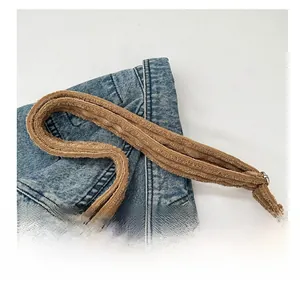 Close-up of the thick comfortable shoulder strap on a brown corduroy tote bag