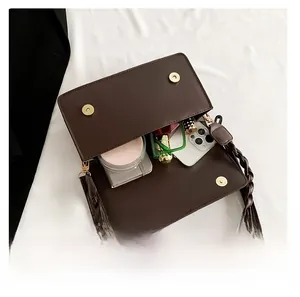 Detail view of the bag interior showing storage for phone, cosmetics, and daily essentials