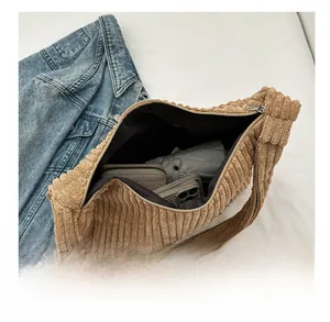 Macro shot of khaki corduroy tote bag showing interior space for phone and umbrella