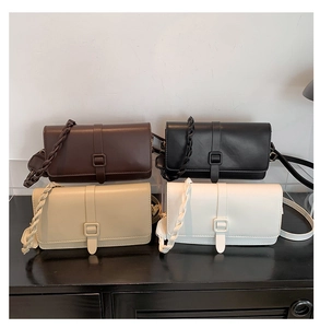 Detail view of stylish crossbody bags in four colors with woven handle and flap closure