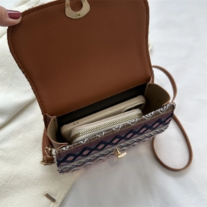 Ethnic retro crossbody bag with semicircular lock showing spacious interior capacity