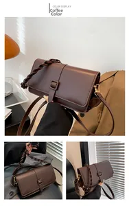 Detail of coffee brown leather square bag with distinctive chunky woven handle and buckle