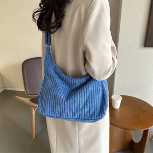 Detailed texture of navy blue corduroy fabric on a minimalist large capacity tote bag