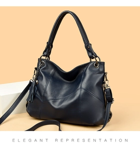 Close-up of navy blue lychee grain PU tote bag with geometric stitching and tassel