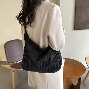 Detail of soft black corduroy tote bag showing the ribbed texture and large capacity