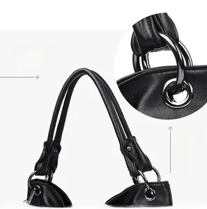 Detailed macro view of the black lychee pattern leather tote handle and metal ring connector