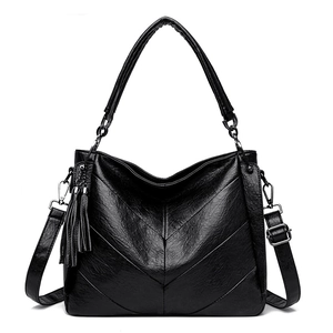 Detail showing high-quality black faux leather texture with V-shaped geometric stitching