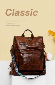 Brown vintage leather backpack with colorful bohemian strap on a minimalist display