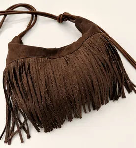 Detailed view of dark brown suede tassel bag with fine fringes and knotted shoulder strap