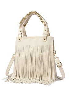 Detail of cream tassel handbag with gold chain handle and adjustable crossbody strap